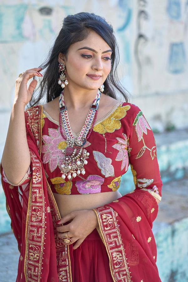 Elegant maroon lehenga choli with intricate swastik and elephant border in dupatta!