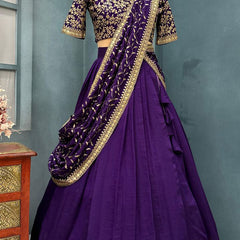 Purple traditional outfit with gold details on a mannequin against a gray background